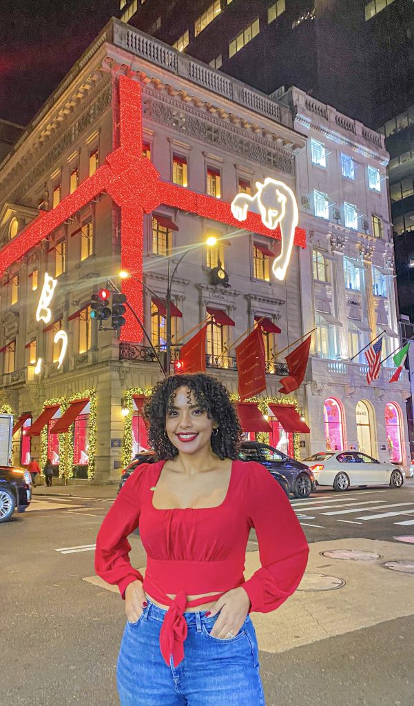 Foto da Camilli com blusa vermelha na frente da loja da Cartier em Nova Iorque